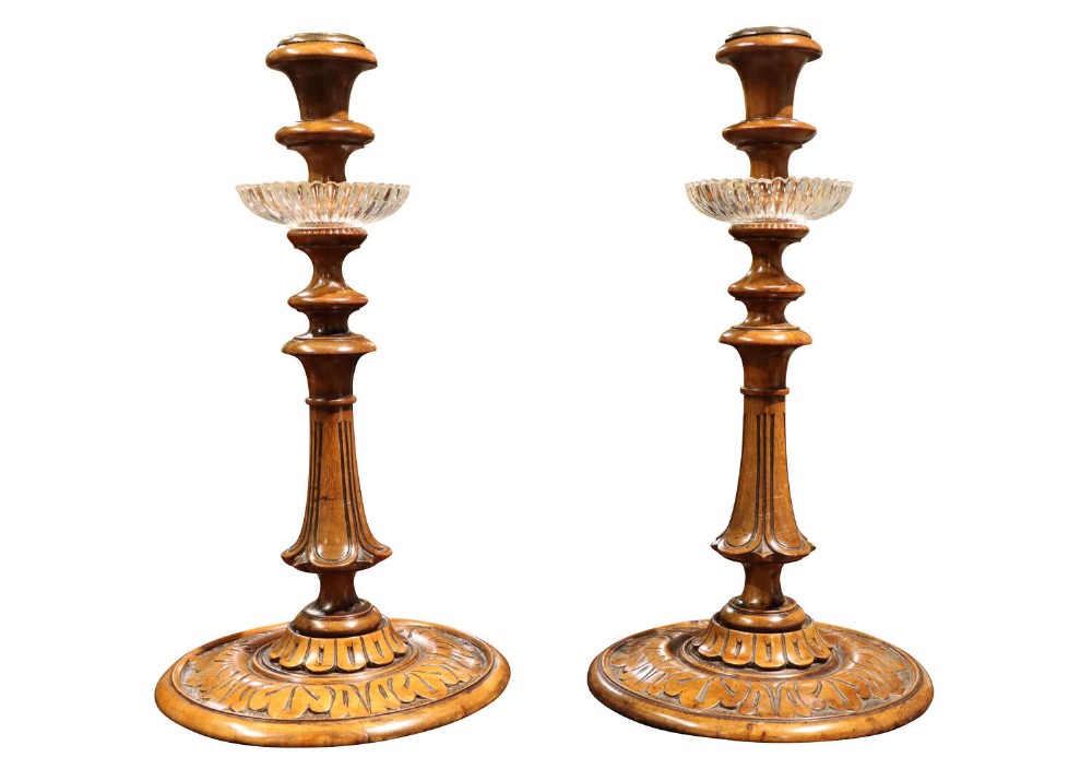A Pair of Carved Walnut Candlesticks