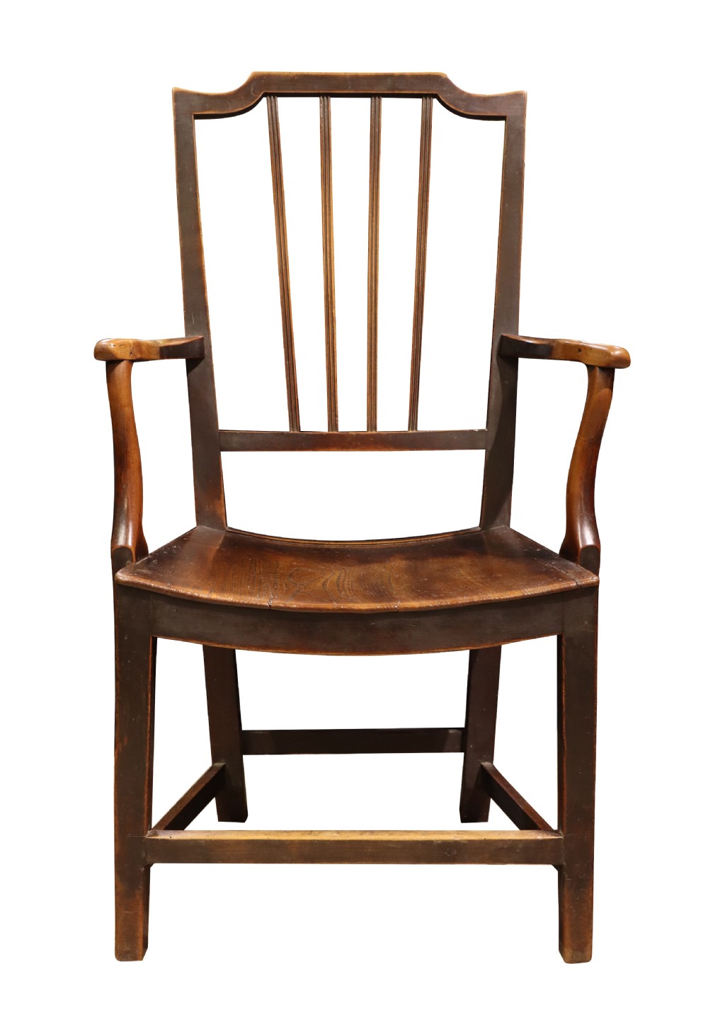 An antique high-backed wooden armchair featuring vertical back slats, curved armrests, a contoured seat, and sturdy square legs connected by stretchers.