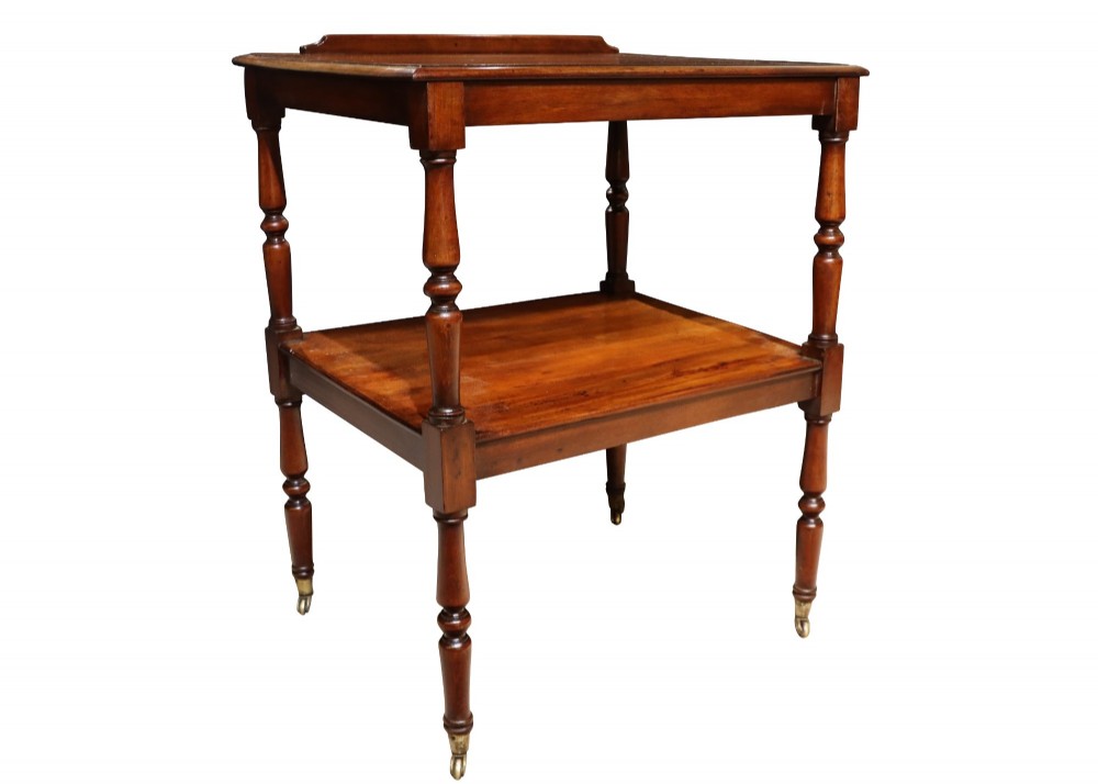 An early 19th-century mahogany two-tier side table featuring turned legs with brass castors and a lower shelf. View II