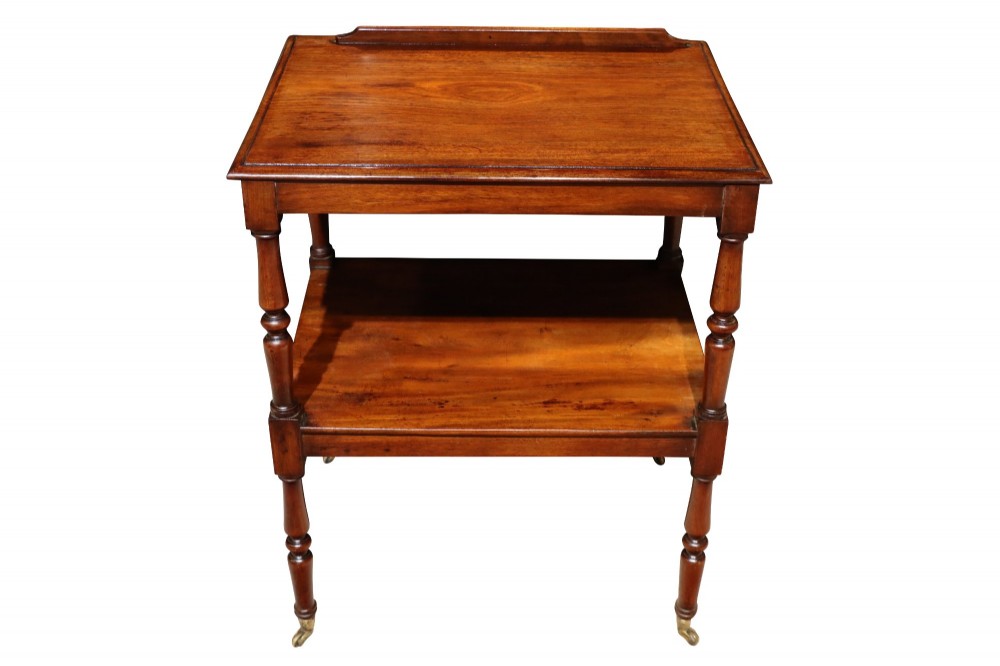 An early 19th-century mahogany two-tier side table featuring turned legs with brass castors and a lower shelf. View III