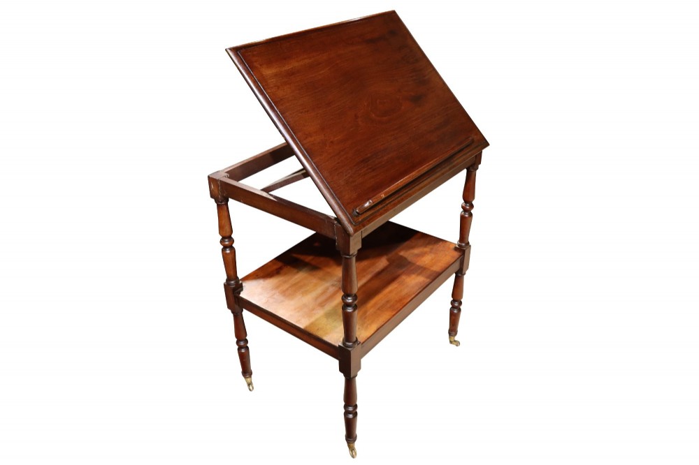 An early 19th-century mahogany two-tier side table featuring turned legs with brass castors and a lower shelf. View V