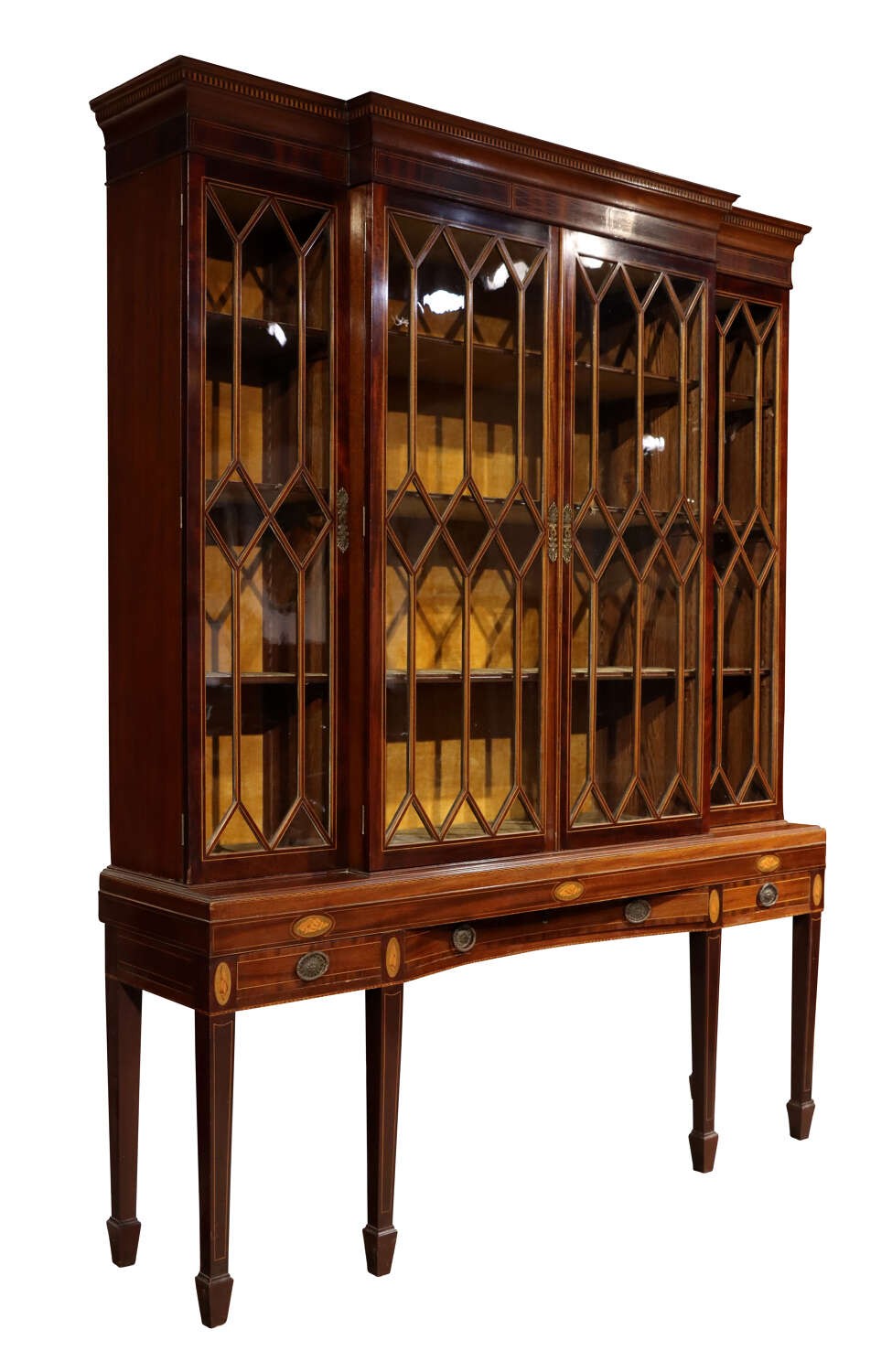 An antique mahogany breakfront display cabinet featuring diamond astragal glazed doors set upon an inlaid stand with square tapered legs. View V
