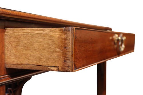 A Georgian mahogany side table featuring a single long drawer with a brass handle, straight square legs, and pierced Gothic corner brackets. View III