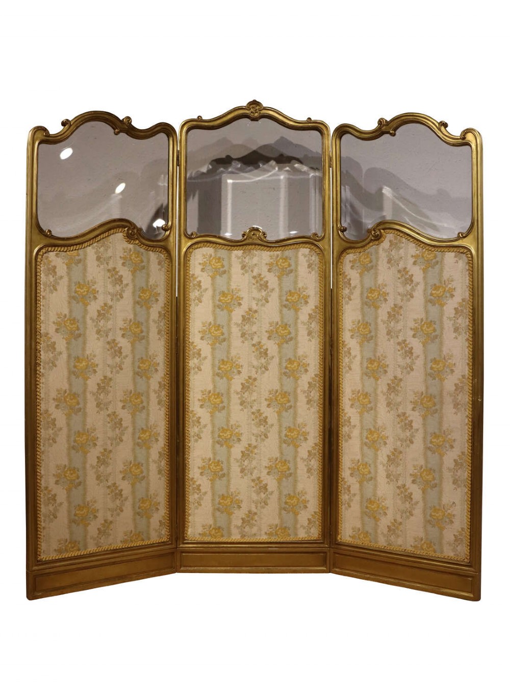 A three-panel French giltwood folding screen featuring shaped bevelled glass top sections and floral-patterned beige silk lower panels.