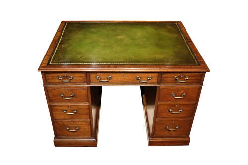 An Edwardian mahogany pedestal desk featuring nine drawers with brass drop handles and a central kneehole opening. View III