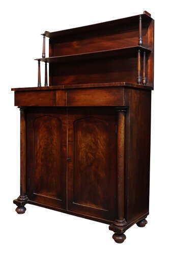 A William IV dark mahogany chiffonier featuring a two-tier shelved upper superstructure supported by turned columns above a two-door cupboard base. View II