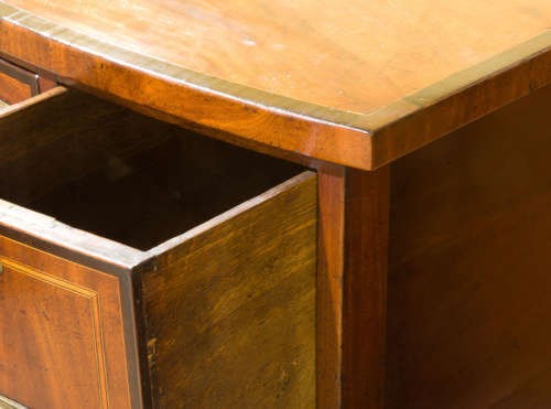 A small George III mahogany bow-front sideboard featuring purpleheart crossbanding, brass handles, an arched central kneehole, and tapered legs. View VIII