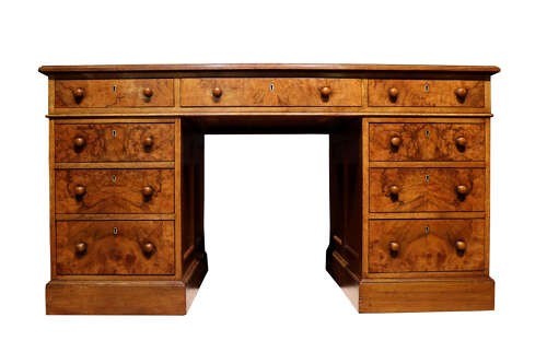 A Victorian burr walnut pedestal desk featuring nine drawers with turned wooden knobs and a red leather gilt-tooled writing surface. View II
