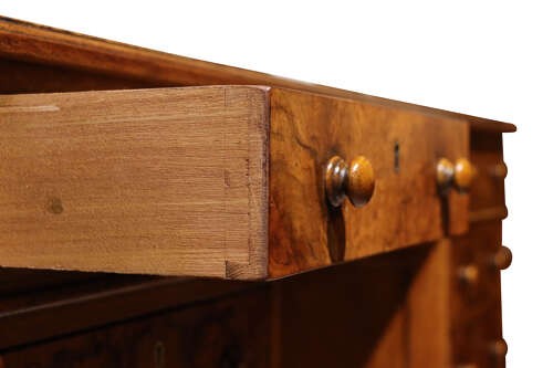 A Victorian burr walnut pedestal desk featuring nine drawers with turned wooden knobs and a red leather gilt-tooled writing surface. View VII