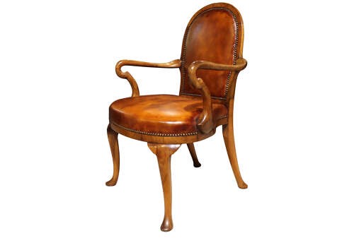 A pair of early twentieth-century walnut armchairs featuring warm tan leather upholstery with brass studding and cabriole legs. View III