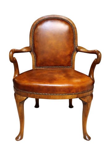 A pair of early twentieth-century walnut armchairs featuring warm tan leather upholstery with brass studding and cabriole legs. View IV
