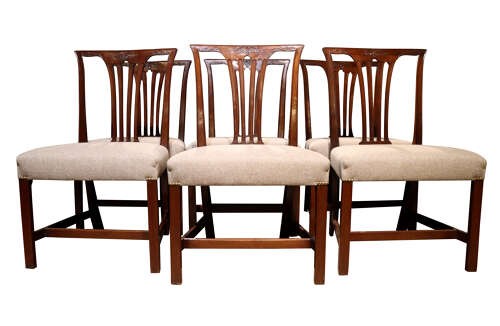 A set of six Georgian mahogany dining chairs featuring carved crest rails, vertical back splats, square legs with stretchers, and beige upholstered seats. View III
