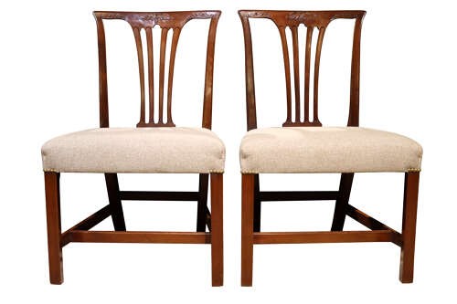 A set of six Georgian mahogany dining chairs featuring carved crest rails, vertical back splats, square legs with stretchers, and beige upholstered seats. View IV