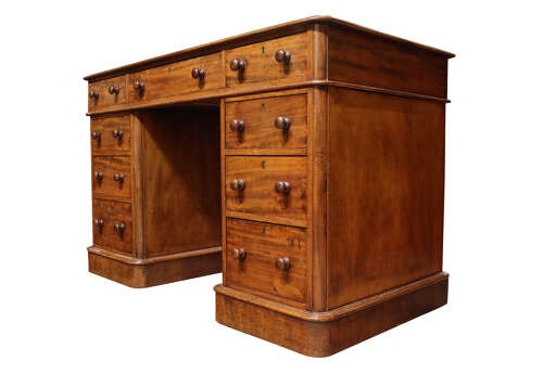 A Victorian mahogany pedestal desk with nine drawers featuring turned wooden handles and a solid plinth base. View IV