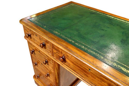 A Victorian mahogany pedestal desk with nine drawers featuring turned wooden handles and a solid plinth base. View V