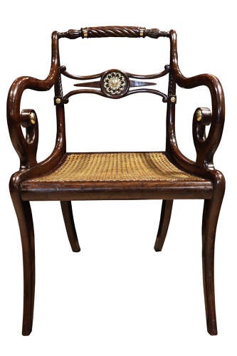 A pair of dark mahogany Regency armchairs featuring swept sabre legs, woven cane seats, rope-twist top rails, and central brass rosette mounts on the backrest splats. View IV