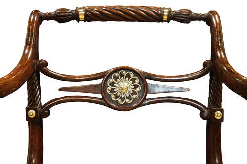 A pair of dark mahogany Regency armchairs featuring swept sabre legs, woven cane seats, rope-twist top rails, and central brass rosette mounts on the backrest splats. View VIII