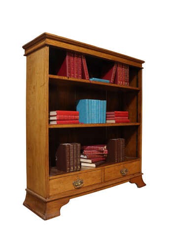 Late 19th-century open oak bookcase featuring three tiers of shelving, two lower drawers with brass drop handles, and a moulded top cornice. View II