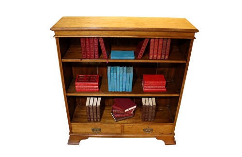 Late 19th-century open oak bookcase featuring three tiers of shelving, two lower drawers with brass drop handles, and a moulded top cornice. View III
