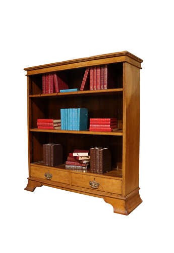 Late 19th-century open oak bookcase featuring three tiers of shelving, two lower drawers with brass drop handles, and a moulded top cornice. View IV