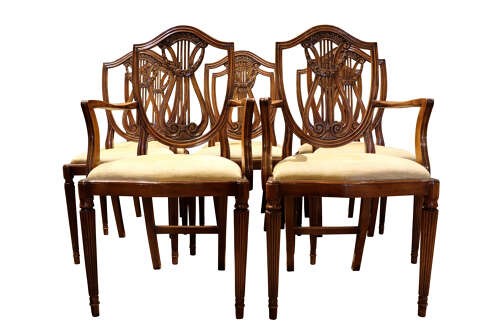 A set of eight mahogany dining chairs with carved lyre backs, fluted legs, and neutral upholstered seats. View II