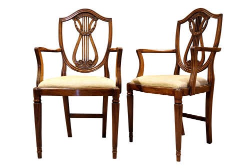 A set of eight mahogany dining chairs with carved lyre backs, fluted legs, and neutral upholstered seats. View VI