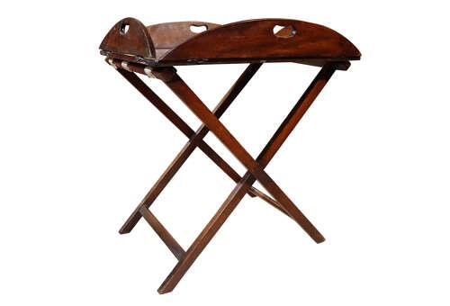 A William IV mahogany butlers tray with carved cutout handles situated on an X-frame folding wooden stand. View II