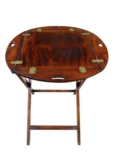 A William IV mahogany butlers tray with carved cutout handles situated on an X-frame folding wooden stand. View VI