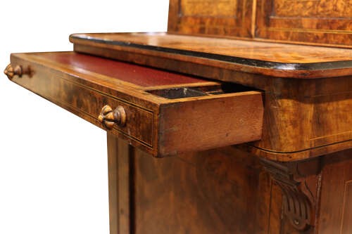 A Victorian burr walnut bureau de dame featuring intricate brass inlay, a top cabinet with twin doors, a full-width drawer, and a lower cupboard set on castors. View VI