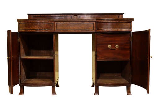 A Regency flame mahogany bow-front pedestal sideboard featuring a low back gallery, central frieze drawer, and two flanking cupboard pedestals on tapered feet. View V