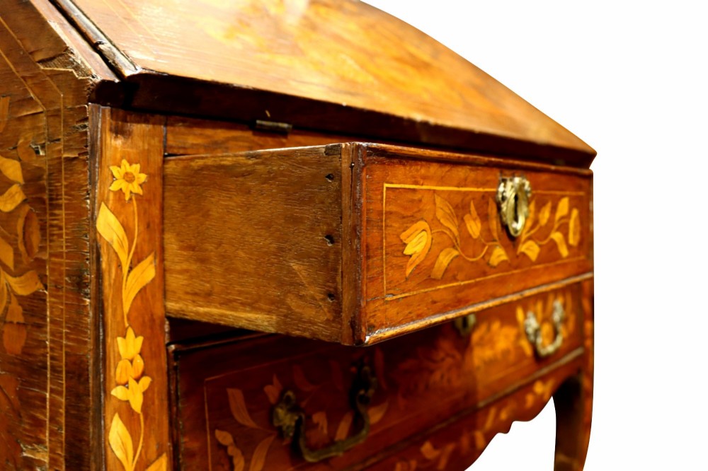 An 18th-century Dutch bureau featuring intricate floral wood marquetry, a sloped fall front, drawers with brass handles, and cabriole legs. View VII