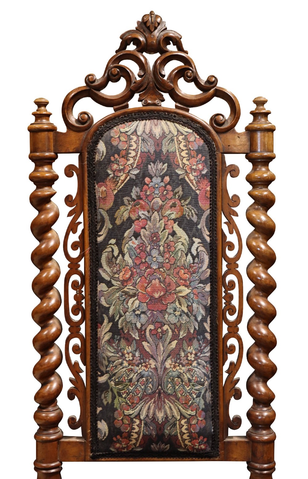 A Victorian carved walnut side chair featuring barley twist columns, a carved scroll cresting rail, cabriole front legs, and floral tapestry upholstery. View VI