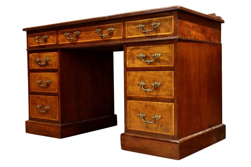 A late Victorian mahogany pedestal desk with satinwood stringing inlay, nine drawers, and brass handles. View IV