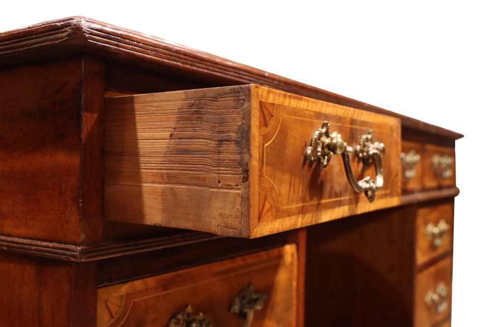 A late Victorian mahogany pedestal desk with satinwood stringing inlay, nine drawers, and brass handles. View VI