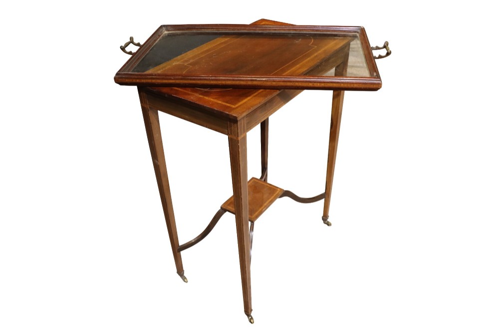 An Edwardian mahogany occasional table featuring a removable tray top with brass handles, satinwood string inlay, tapered legs, brass castors, and a lower X-form stretcher with a central platform. View III