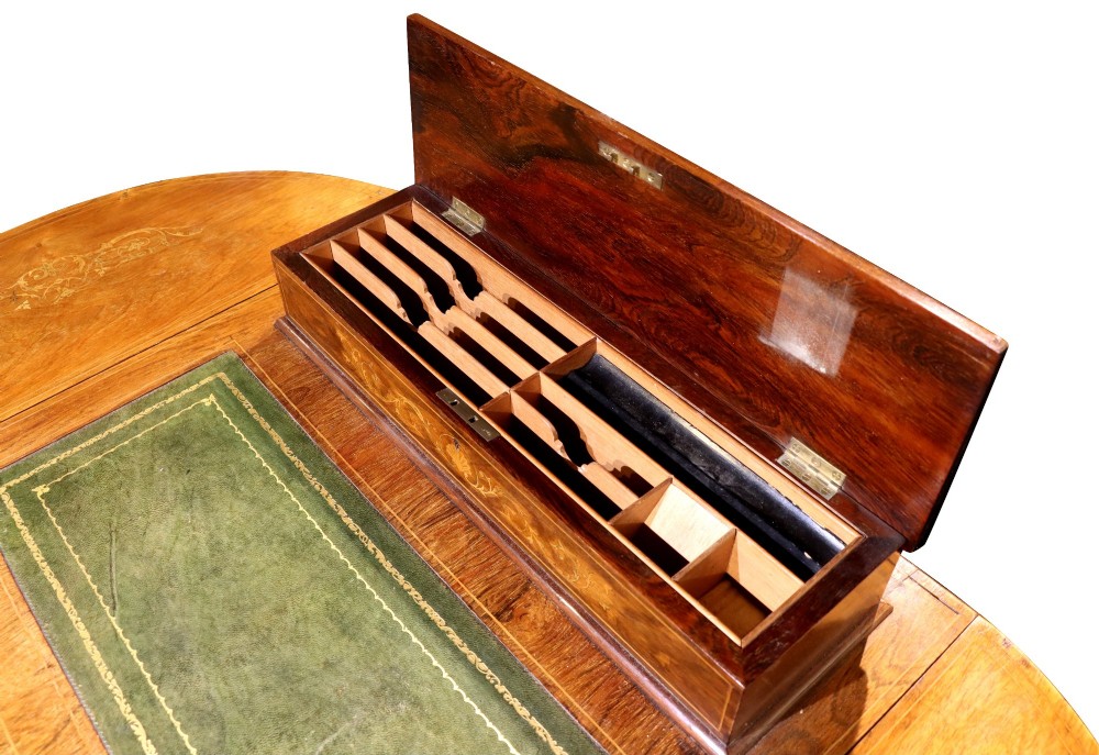 An Edwardian rosewood writing table featuring a green leather writing surface, satinwood floral marquetry inlay, drop-leaf side panels, and a superstructure with brass gallery railing. View VIII