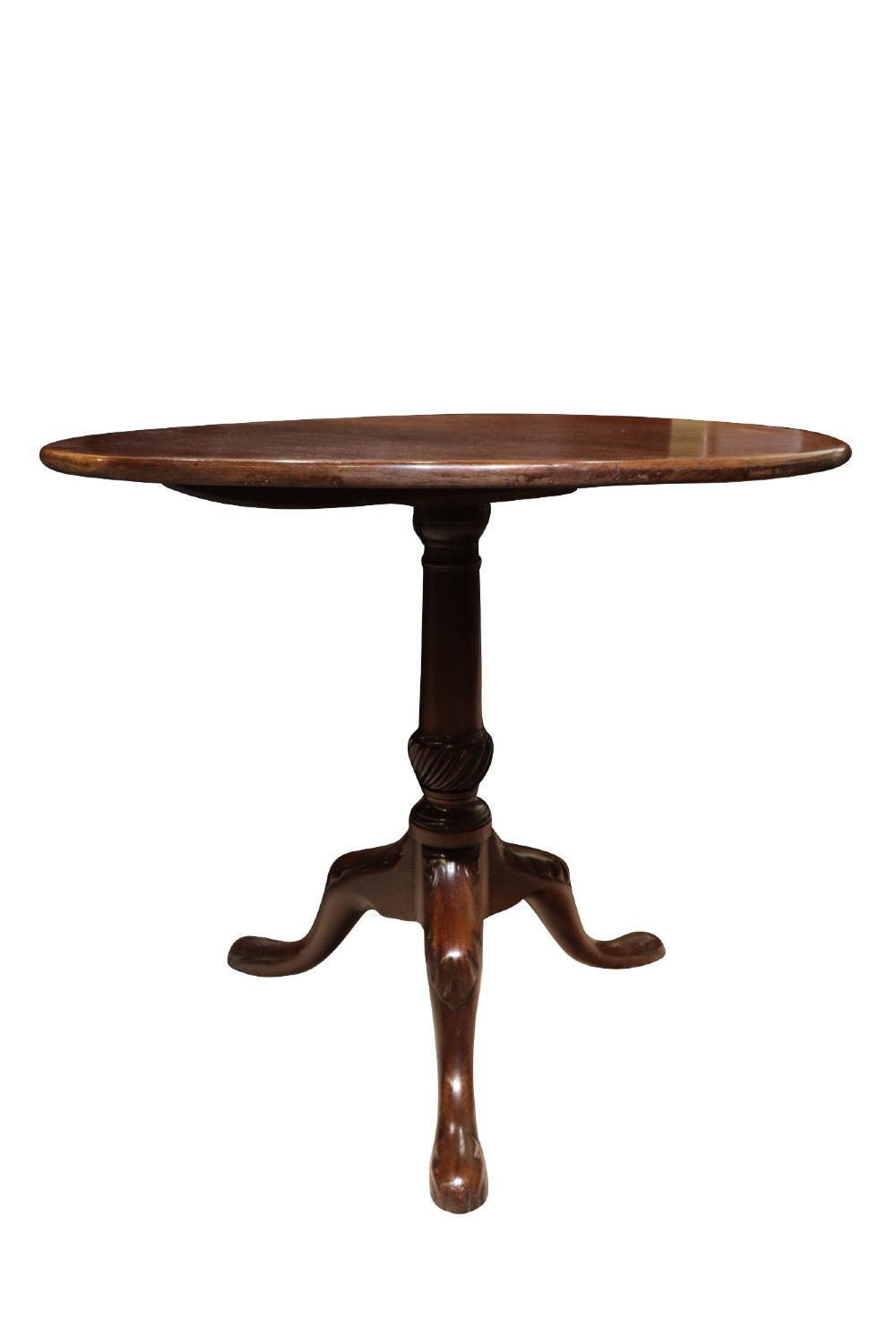 A George IV circular mahogany tilt-top table featuring a turned central column with carved detailing and a tripod base resting on pad feet. View III