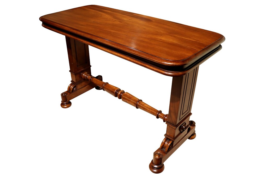 A William IV polished mahogany three-tier buffet table featuring a mechanical rise and fall shelf structure supported by double upright columns and a carved trestle base. View IV