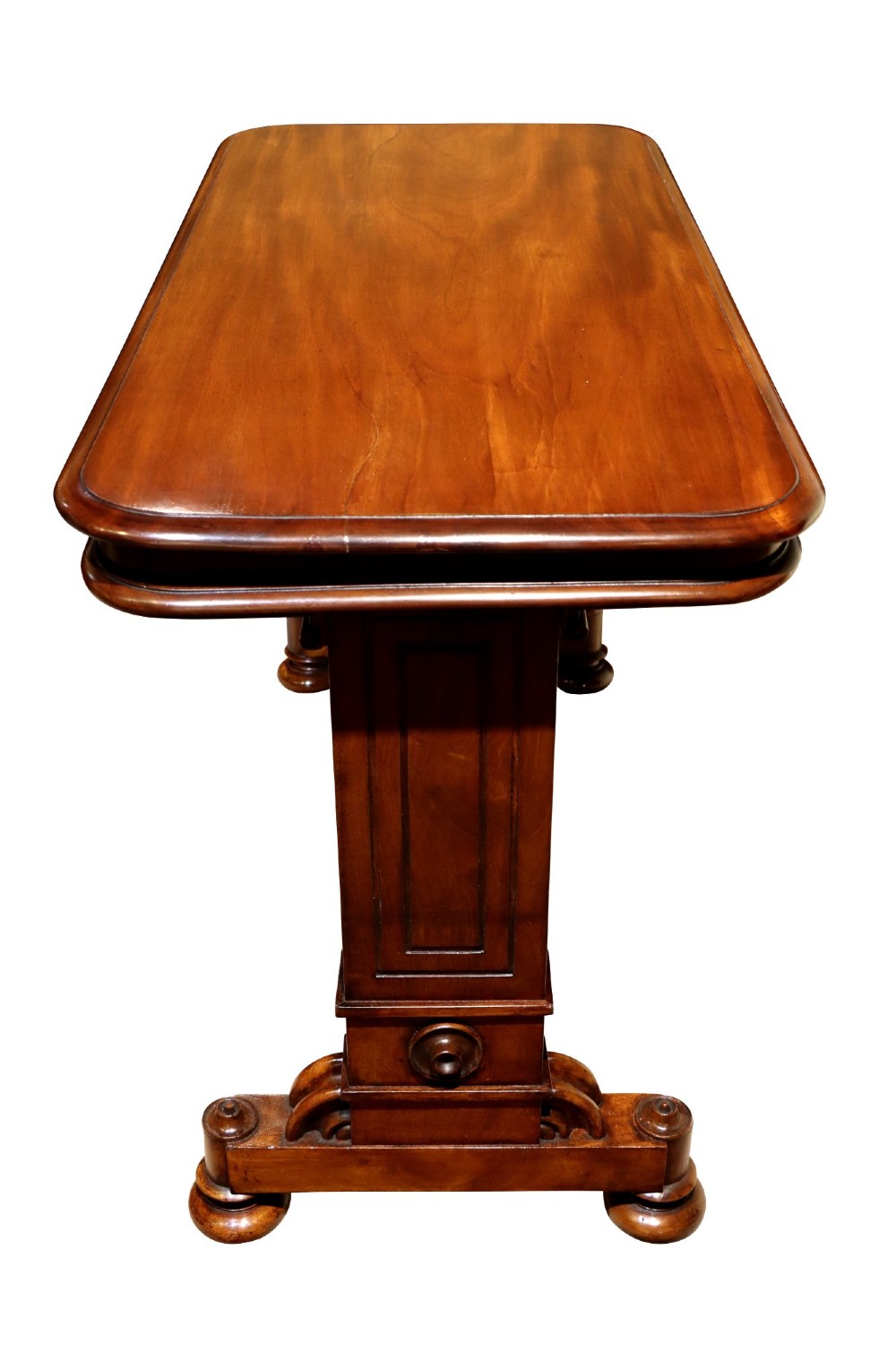 A William IV polished mahogany three-tier buffet table featuring a mechanical rise and fall shelf structure supported by double upright columns and a carved trestle base. View VI
