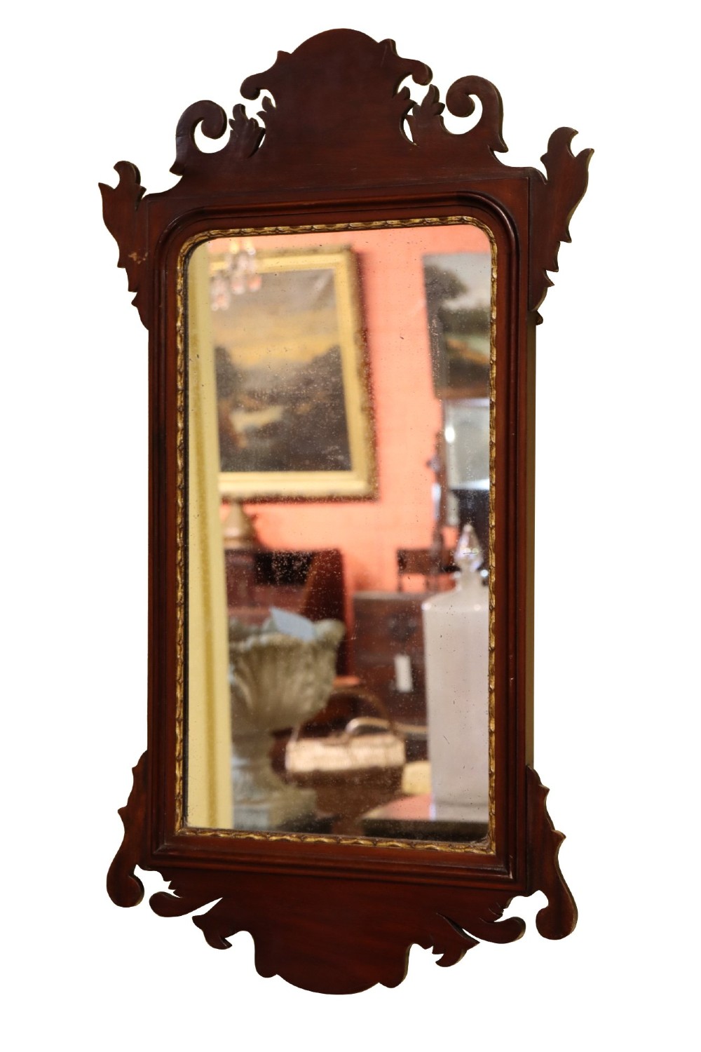 A Victorian Chippendale style mahogany wall mirror featuring decorative fretwork scroll cresting and a gilded inner slip border. View IV