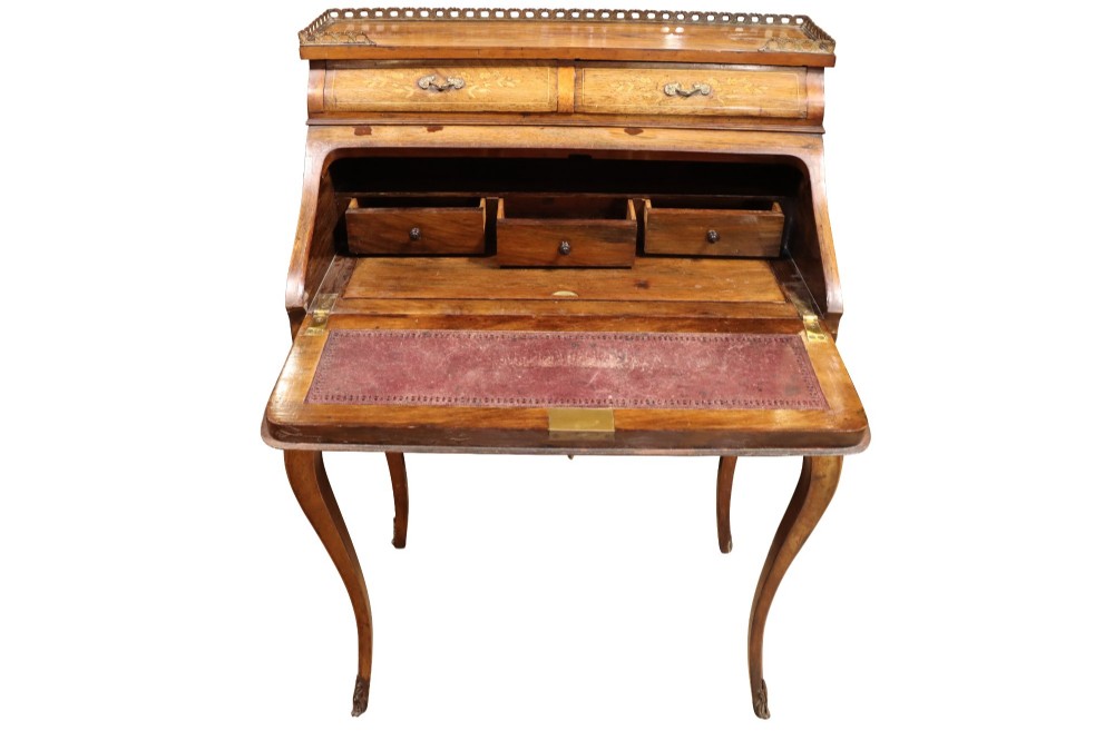A 19th-century French Louis XV style bonheur-du-jour writing desk featuring floral marquetry inlay, slender cabriole legs, a slant-front writing slope, and brass mounts. View V