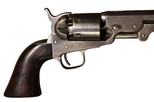 An antique Colt Model 1851 Navy percussion revolver featuring a grey steel frame, an octagonal barrel, a six-shot cylinder, and a dark walnut grip. View VIII