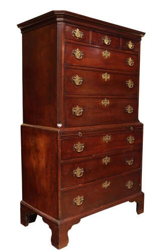 A tall George III mahogany chest on chest featuring two stacked sections with graduated drawers, decorative pierced brass handles, and bracket feet. View IV
