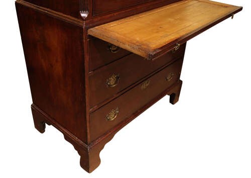 A tall George III mahogany chest on chest featuring two stacked sections with graduated drawers, decorative pierced brass handles, and bracket feet. View V