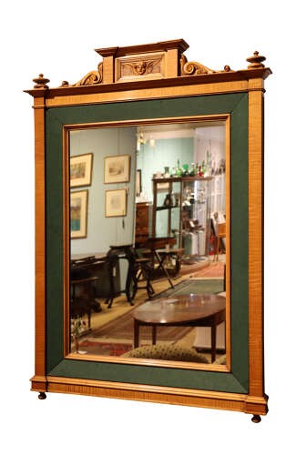 An Edwardian satinwood rectangular wall mirror featuring an inner green fabric border, top pediment with a carved cherub crest, and turned corner finials. View III