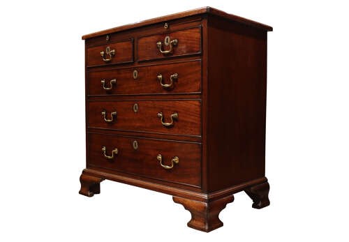 A George III mahogany chest of drawers featuring brass swan-neck handles, an upper brushing slide, and bracket feet. View III