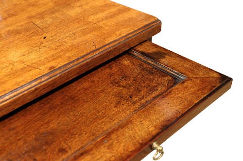 A George III mahogany chest of drawers featuring brass swan-neck handles, an upper brushing slide, and bracket feet. View VII