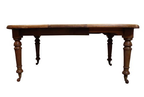 A Victorian oak extending dining table featuring rounded D-ends, a removable centre leaf, and four turned legs on brass castors. View IV