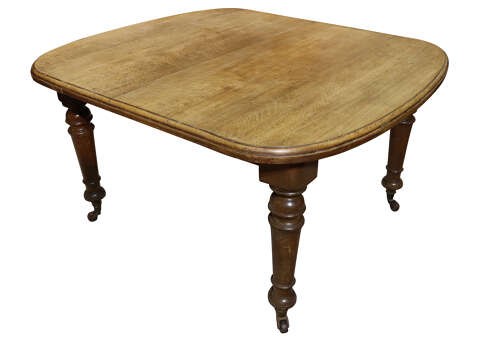 A Victorian oak extending dining table featuring rounded D-ends, a removable centre leaf, and four turned legs on brass castors. View VI