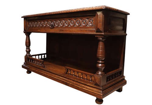 A French Henri II style dark oak enfilade with a carved frieze drawer, turned column supports, and an open lower shelf framed by a spindle rail. View IV